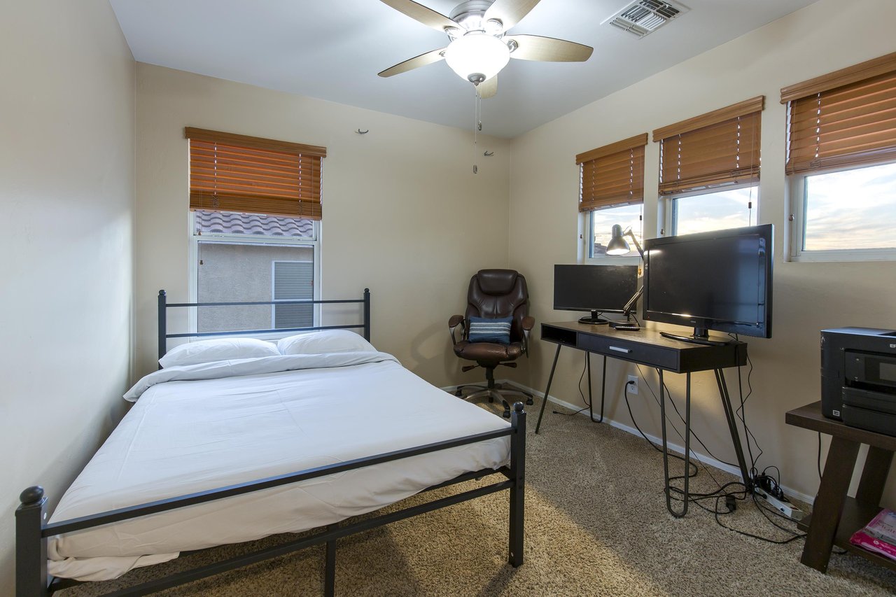 Queen size bed, desk space, and flatscreen TV.