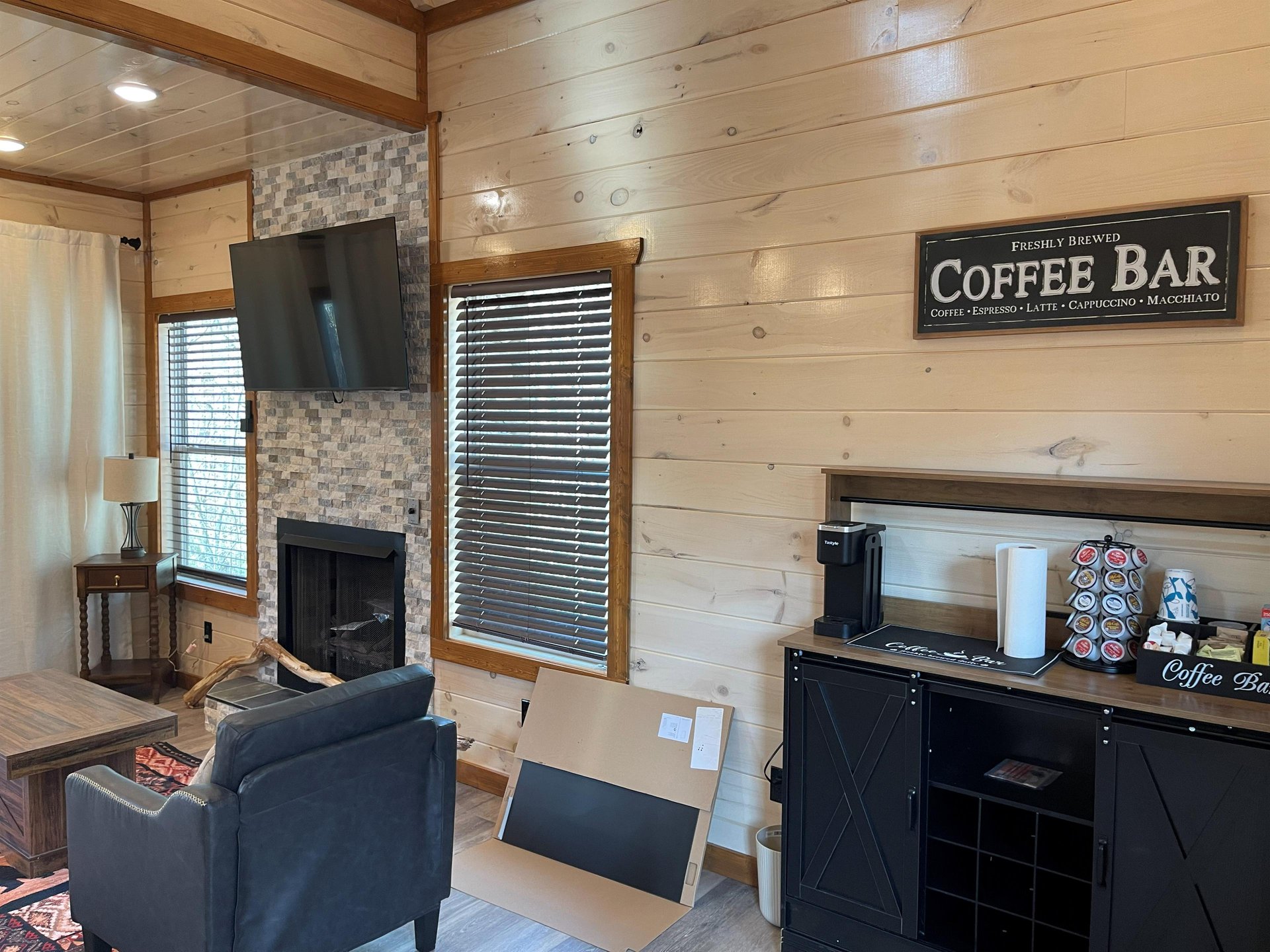 Cozy up in your rustic living room with exposed beams, stone fireplace, and your own coffee bar for perfect mornings.