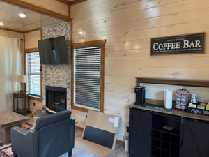 Cozy up in your rustic living room with exposed beams, stone fireplace, and your own coffee bar for perfect mornings.