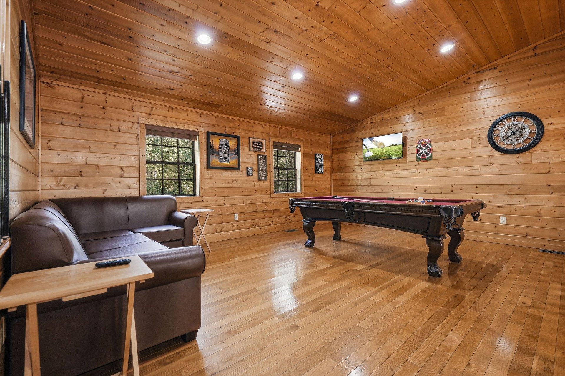 Challenge friends to pool while relaxing on leather sofas in your rustic wood game room retreat.