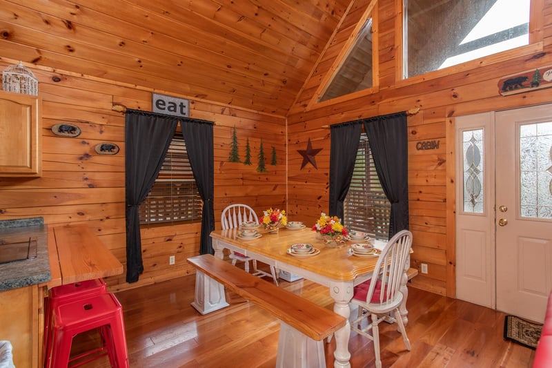 Seating for six at the dining room table at Hibernation Station, a 3bedroom cabin rental located in Pigeon Forge