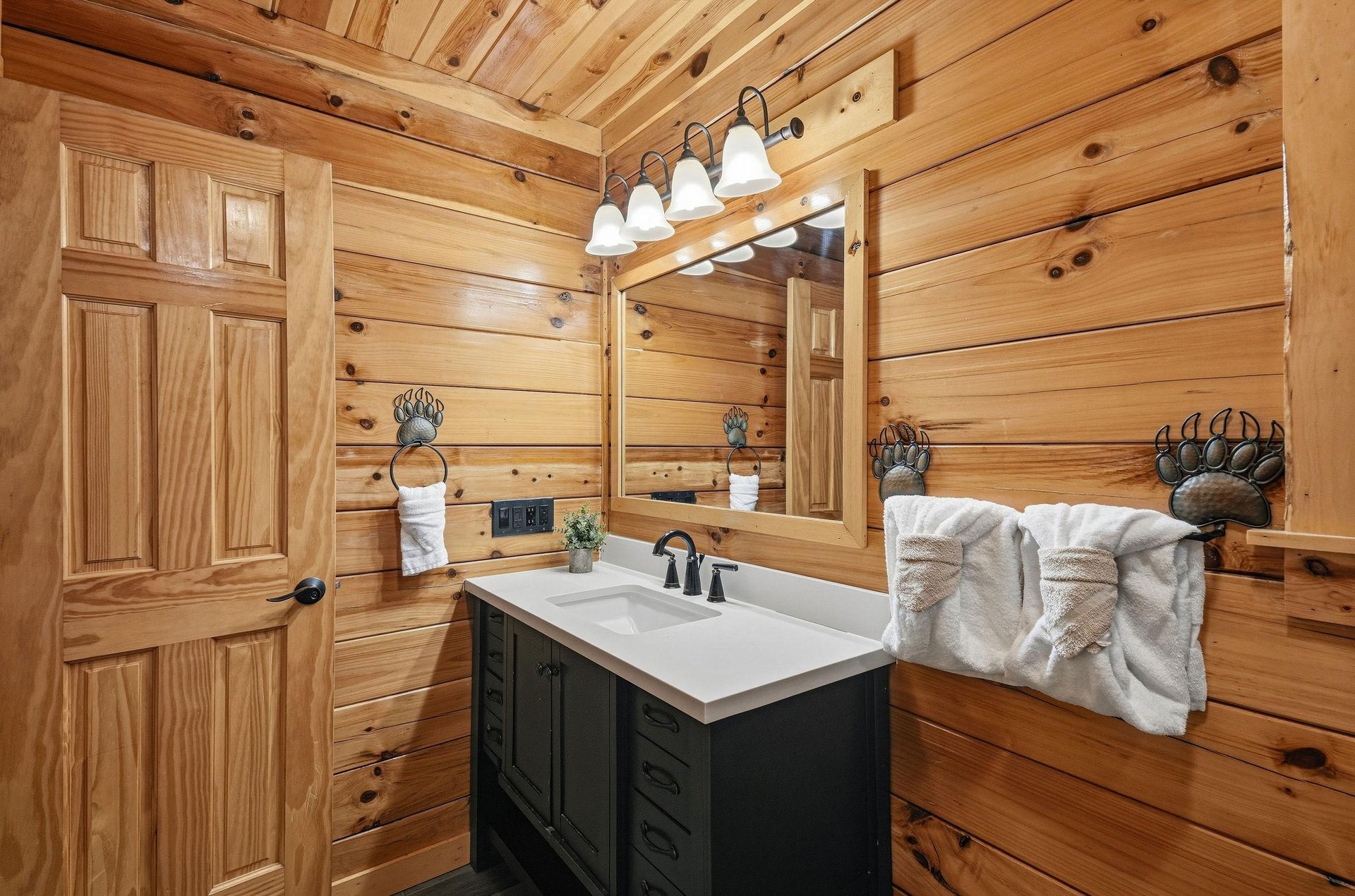 Rustic charm meets modern comfort in this handcrafted bathroom, where rich wood walls and elegant fixtures create your perfect mountain retreat.