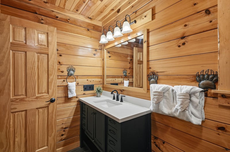 Rustic charm meets modern comfort in this handcrafted bathroom, where rich wood walls and elegant fixtures create your perfect mountain retreat.