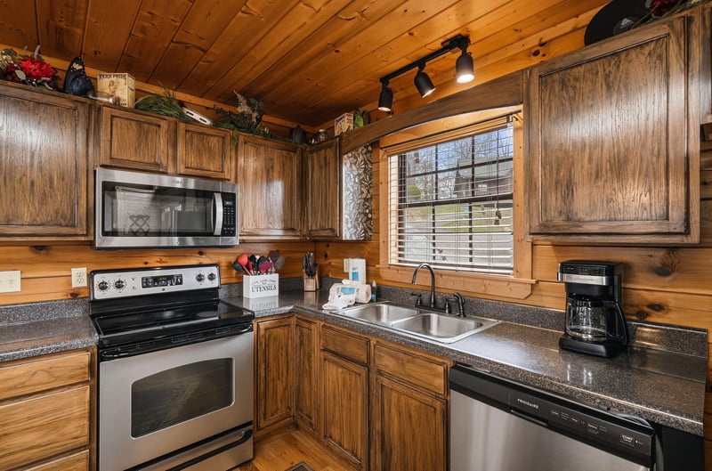 Your fully equipped kitchen blends rustic charm with modern convenience—rich wood cabinets, granite counters, and quality appliances await your culinary adventures.