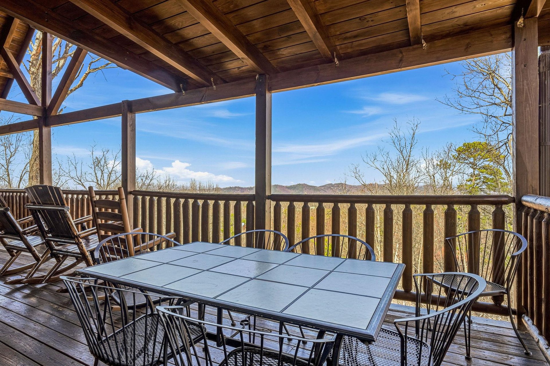 Covered deck with mountain views where youll savor morning coffee and evening meals while watching seasons change across rolling hills.