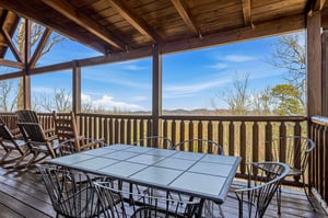 Covered deck with mountain views where youll savor morning coffee and evening meals while watching seasons change across rolling hills.