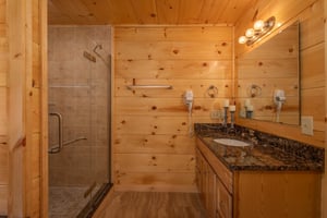 Walk in shower with single vanity sink