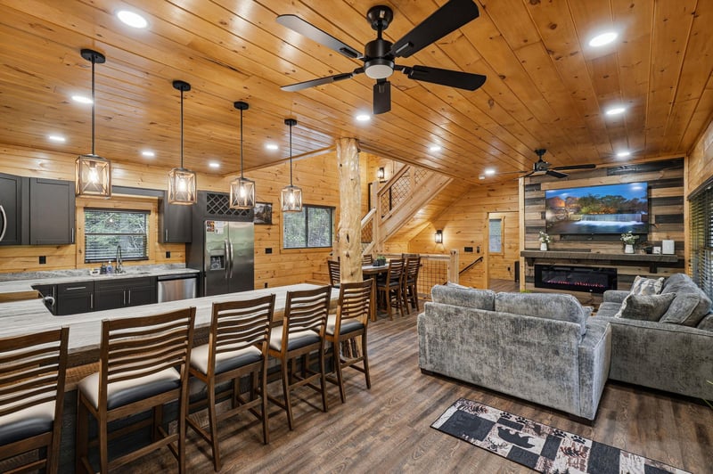 Step into your cozy mountain retreat where rustic wood beams meet modern comfort, creating the perfect space to gather and unwind.