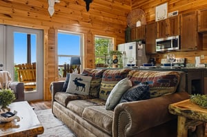 Step into this cozy cabin where rustic pine walls and charming wildlife accents invite you to unwind. Your open living space flows to a deck, perfect for morning coffee with natures backdrop.