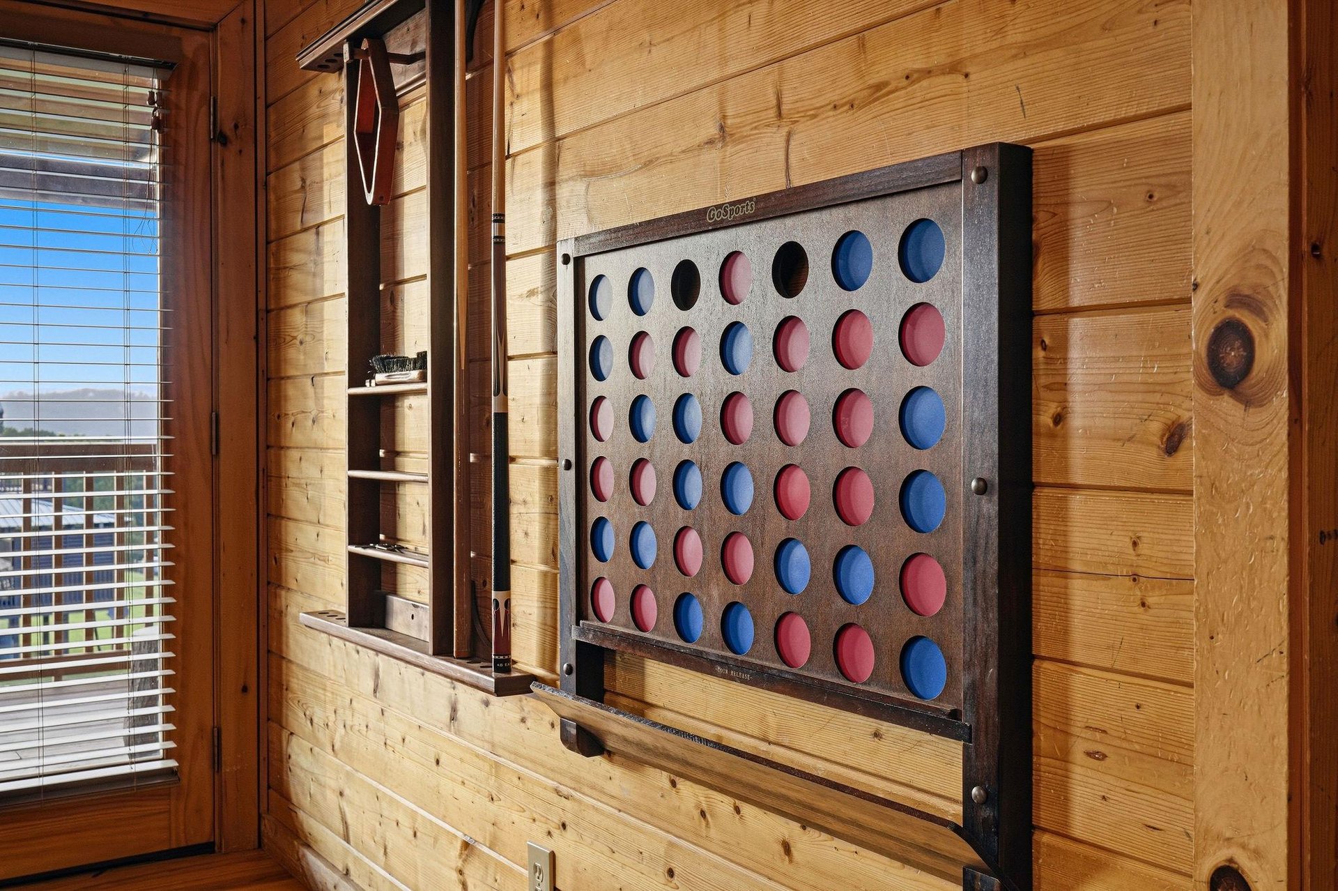 Challenge friends and family to a classic game at this wallmounted Connect Four board—perfect for cozy nights in your cabin retreat.