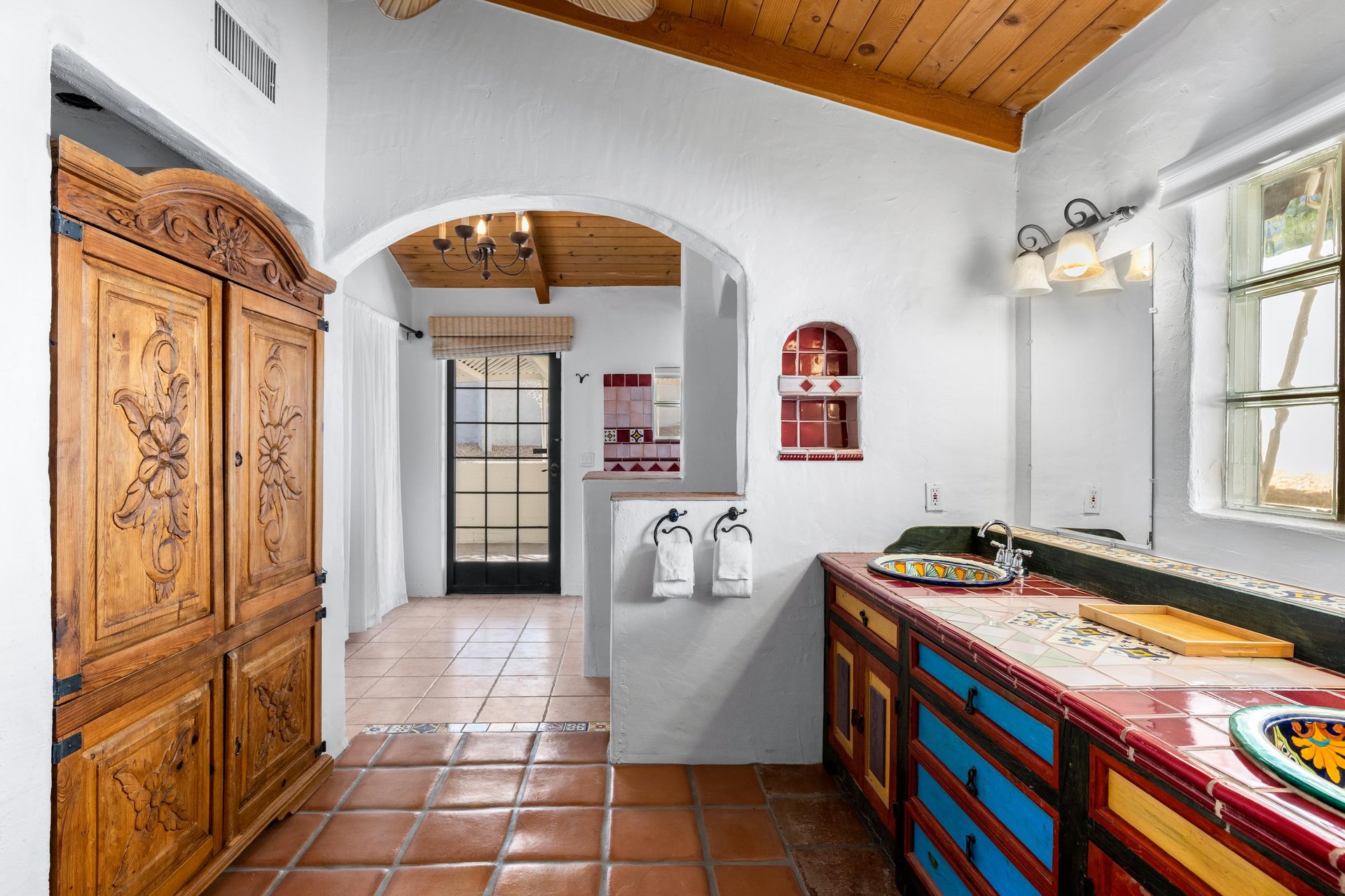 Casita bathroom with dual vanity sinks, shower and washer and dryer