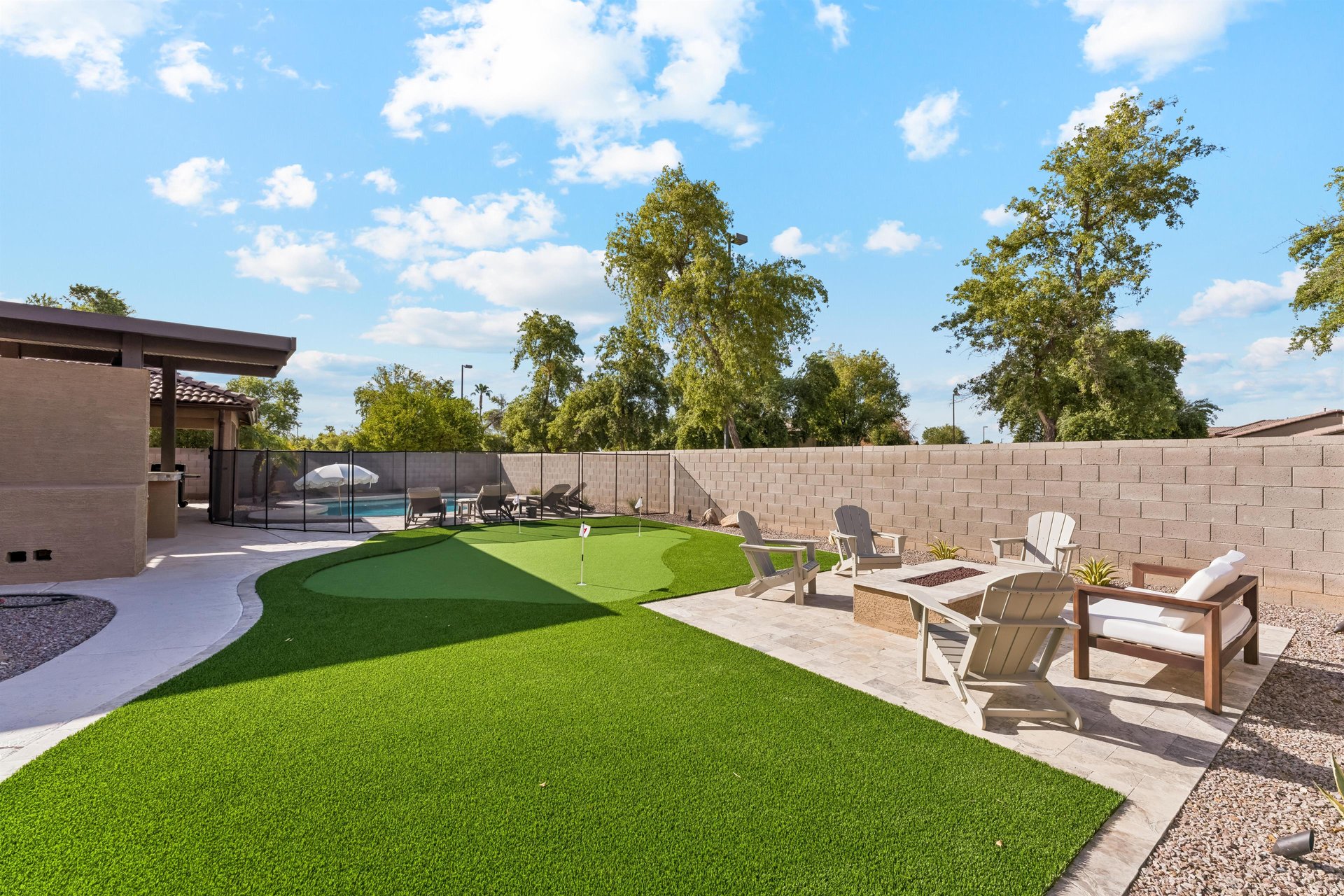 Private putting green next to the patio and pool area.