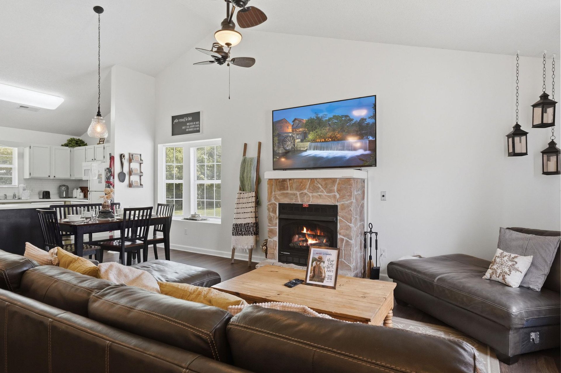 Unwind in your spacious living area with plush leather sofas, a warm stone fireplace, and a large TV—perfect for cozy evenings after exploring.