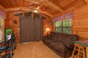 living room with couch and television at angels dream a 1 bedroom cabin rental located in gatlinburg