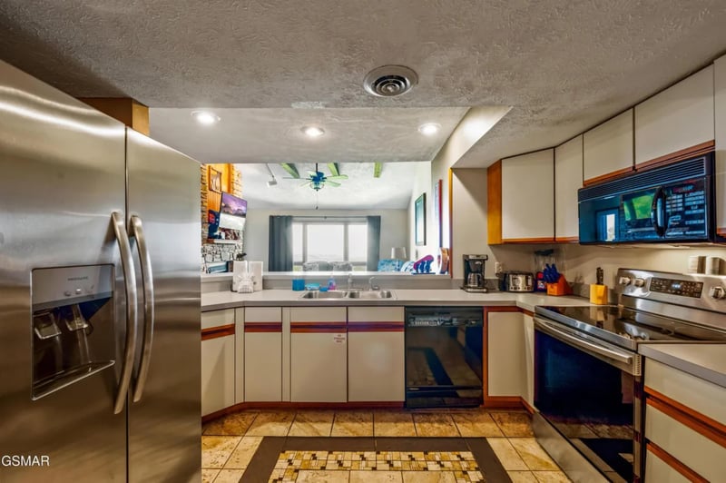 Your fully equipped kitchen awaits with stainless steel appliances, granite counters, and everything needed to create memorable meals together.