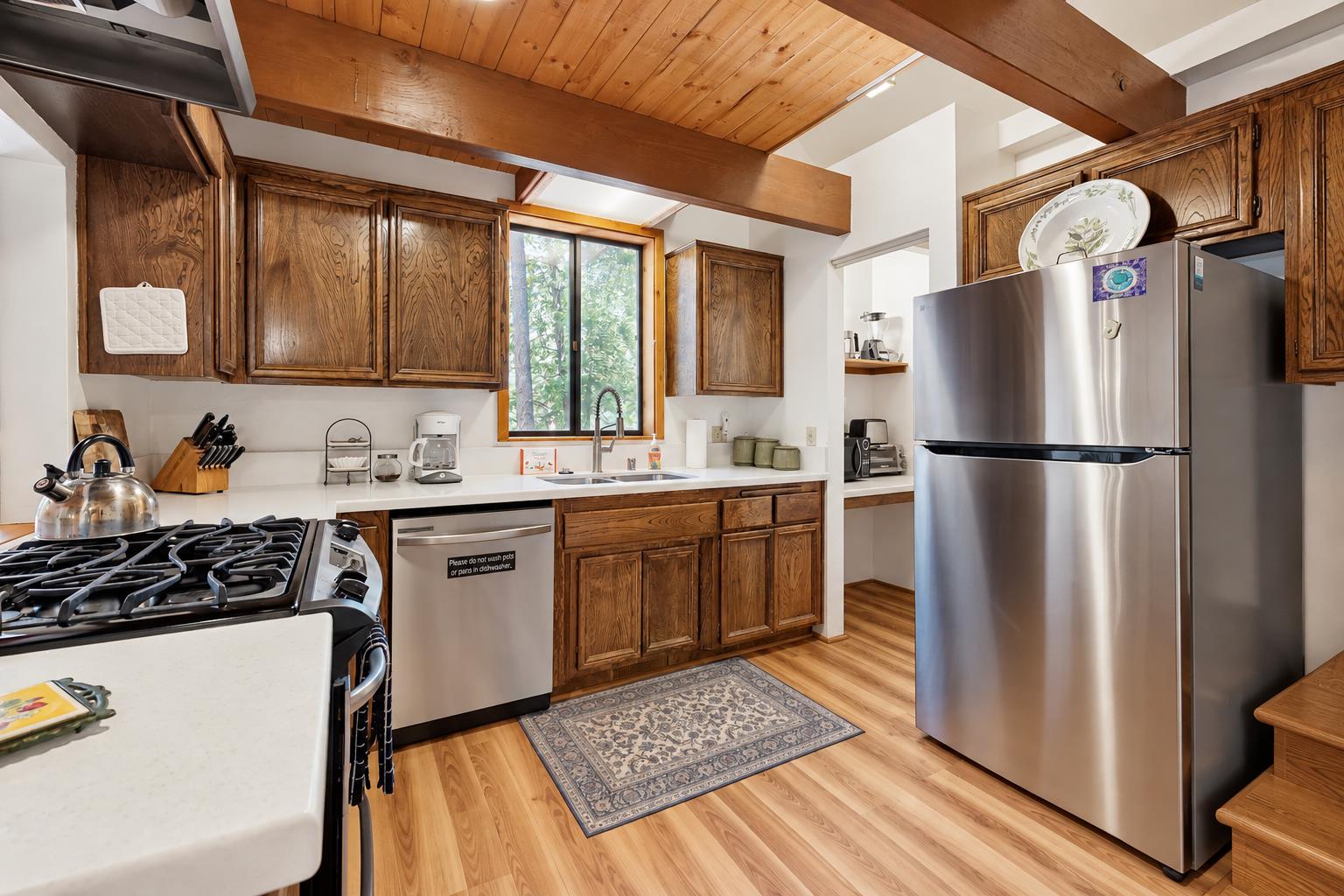 A fully equipped kitchen with updated countertops, stainless steel appliances, and plenty of cabinet space — everything you need to cook up a mountain meal.