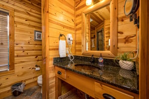 Single vanity sink separated from toilet