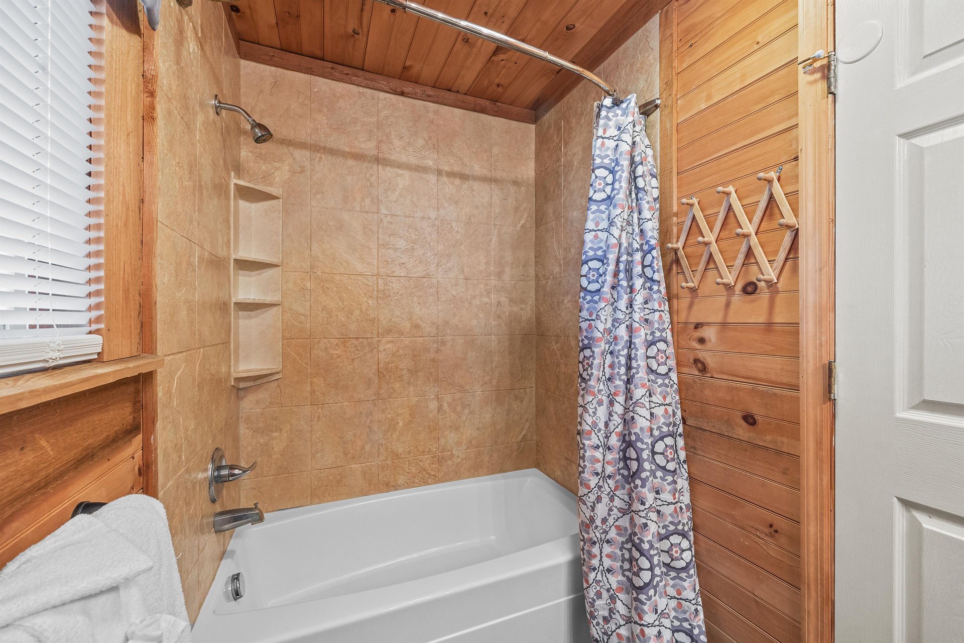 Bathroom with a tub and shower at Living on Love, a 2 bedroom cabin rental located in Pigeon Forge