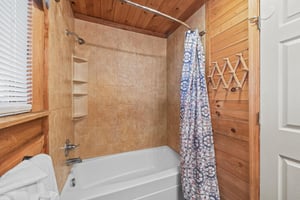 Bathroom with a tub and shower at Living on Love, a 2 bedroom cabin rental located in Pigeon Forge