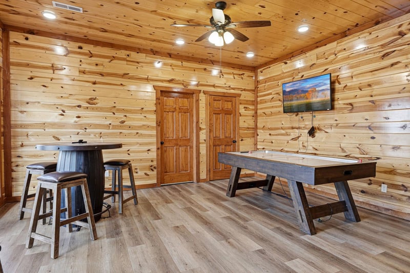 Your rustic game room awaits with air hockey and hightop seating surrounded by warm knotty pine walls.