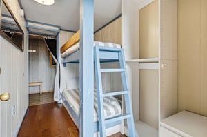 Cozy bunk beds with crisp linens offer comfortable sleeping quarters in your charming cabinstyle retreat.