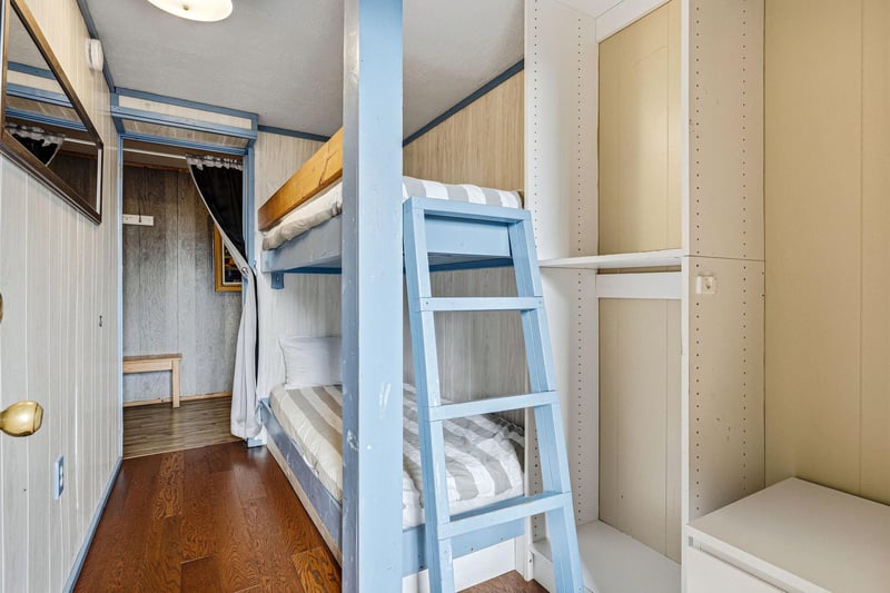 Cozy bunk beds with crisp linens offer comfortable sleeping quarters in your charming cabinstyle retreat.