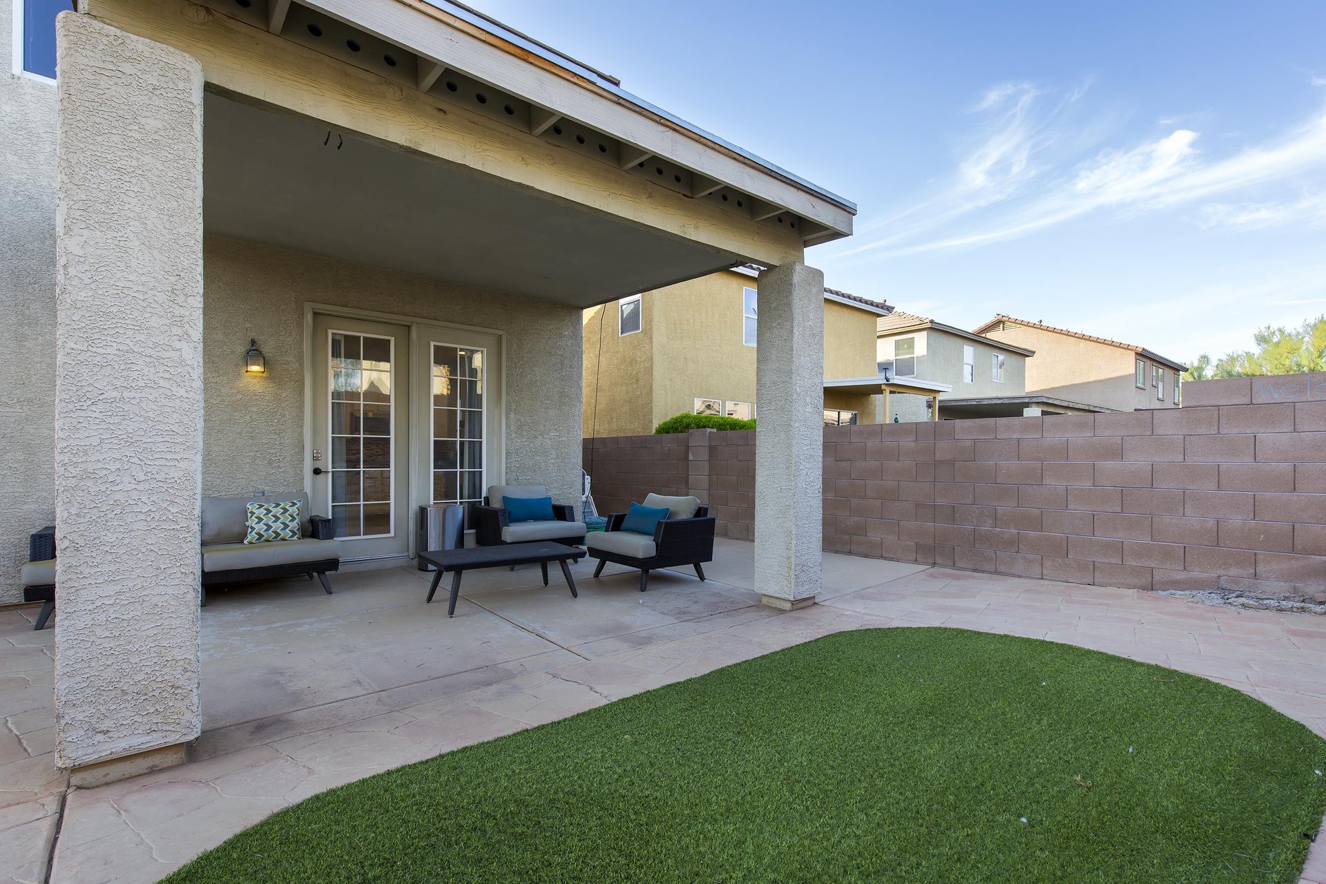Fully fenced, spacious yard with outdoor seating.