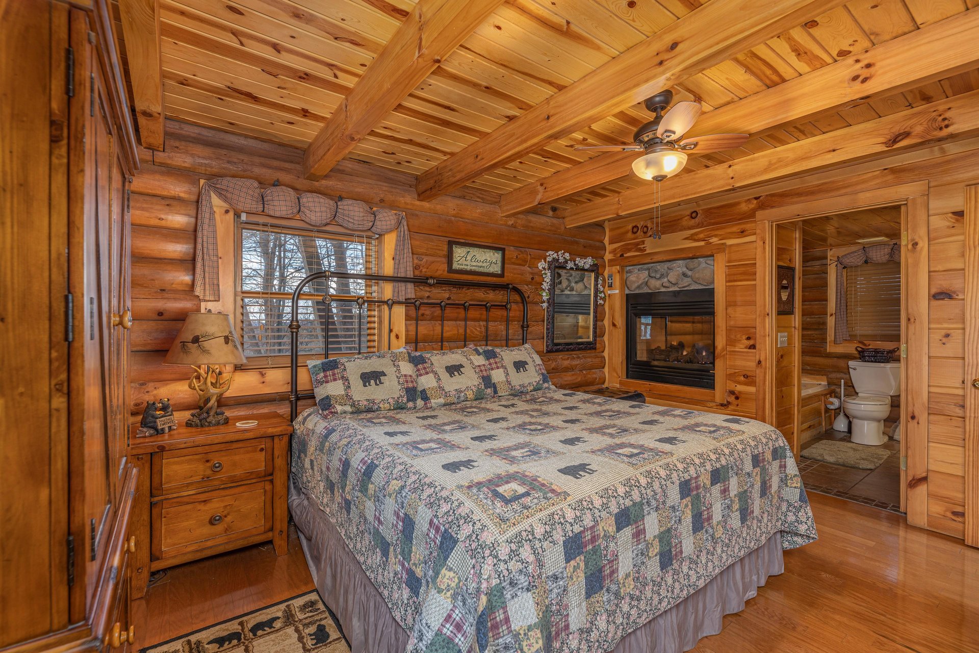 Bedroom with a doublesided fireplace at A Lovers Secret, a 1 bedroom cabin rental located in Gatlinburg