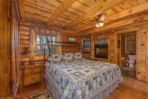 Bedroom with a doublesided fireplace at A Lovers Secret, a 1 bedroom cabin rental located in Gatlinburg