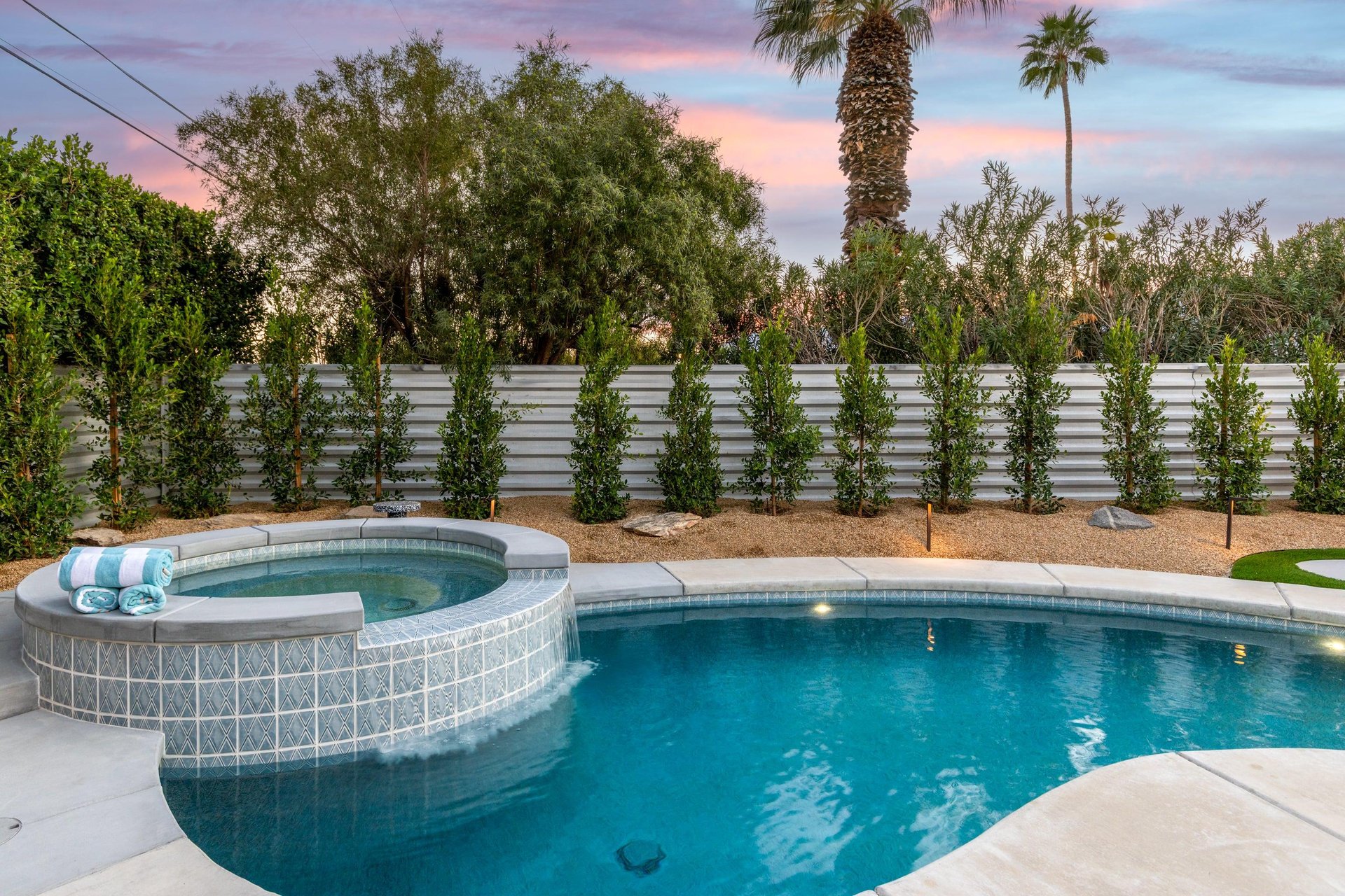 Integrated spa and pool with waterfall feature