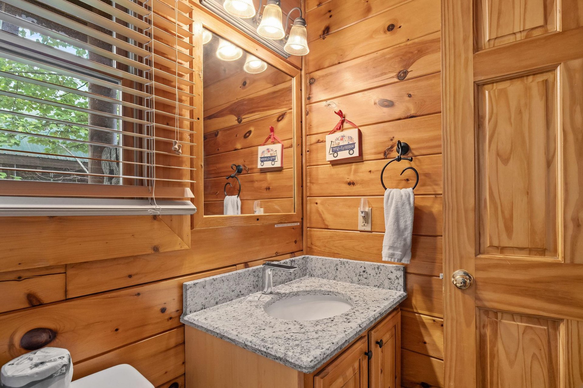 single vanity sink with window above toilet