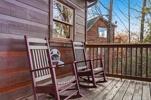 Unwind in your private rocking chairs on this peaceful deck, where youll sip morning coffee while watching sunlight dance through towering trees.