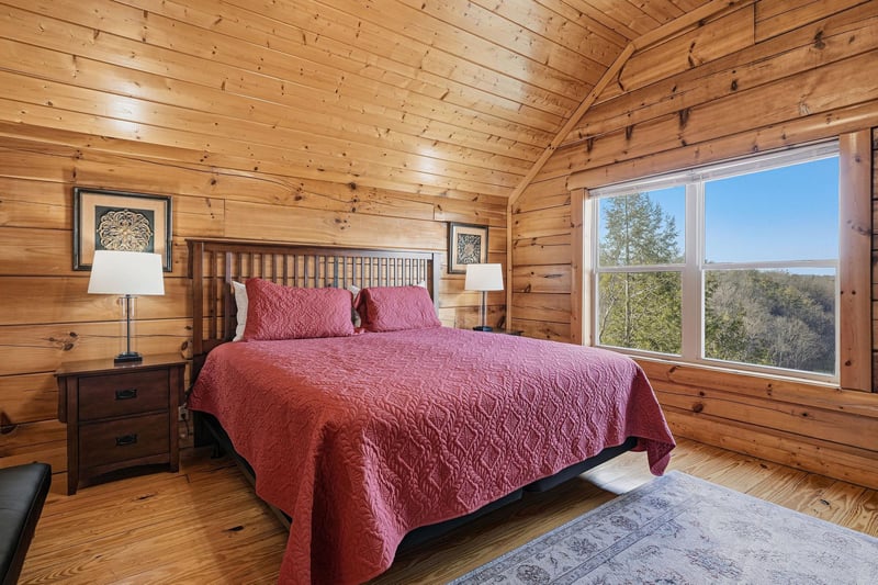 Drift off to sleep surrounded by warm wood walls with natural light streaming through your window overlooking peaceful treetops.