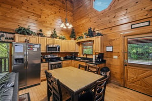 Gather around your spacious kitchens dining table where rustic charm meets modern convenience, surrounded by warm wood and natural light.