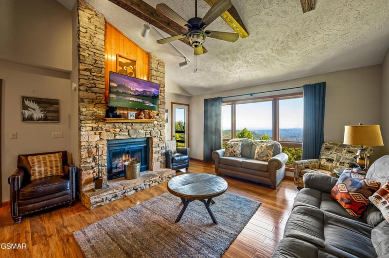 Sink into comfortable seating beside your crackling fireplace while mountain views stretch endlessly beyond the windows.