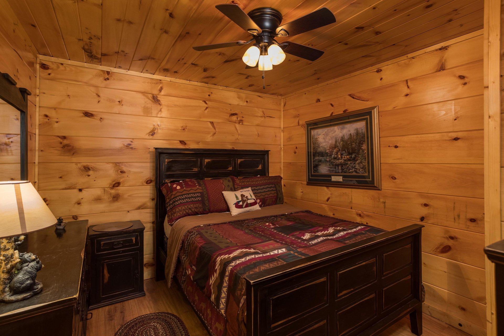 Bedroom with a bed, night stand, and dresser at Graceland, a 4bedroom cabin rental located in Pigeon Forge