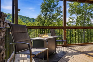 Step outside to your private covered deck and unwind with stunning mountain and forest views stretching beyond the railing. A cozy fire table waits, perfect for morning coffee or evening gatherings un
