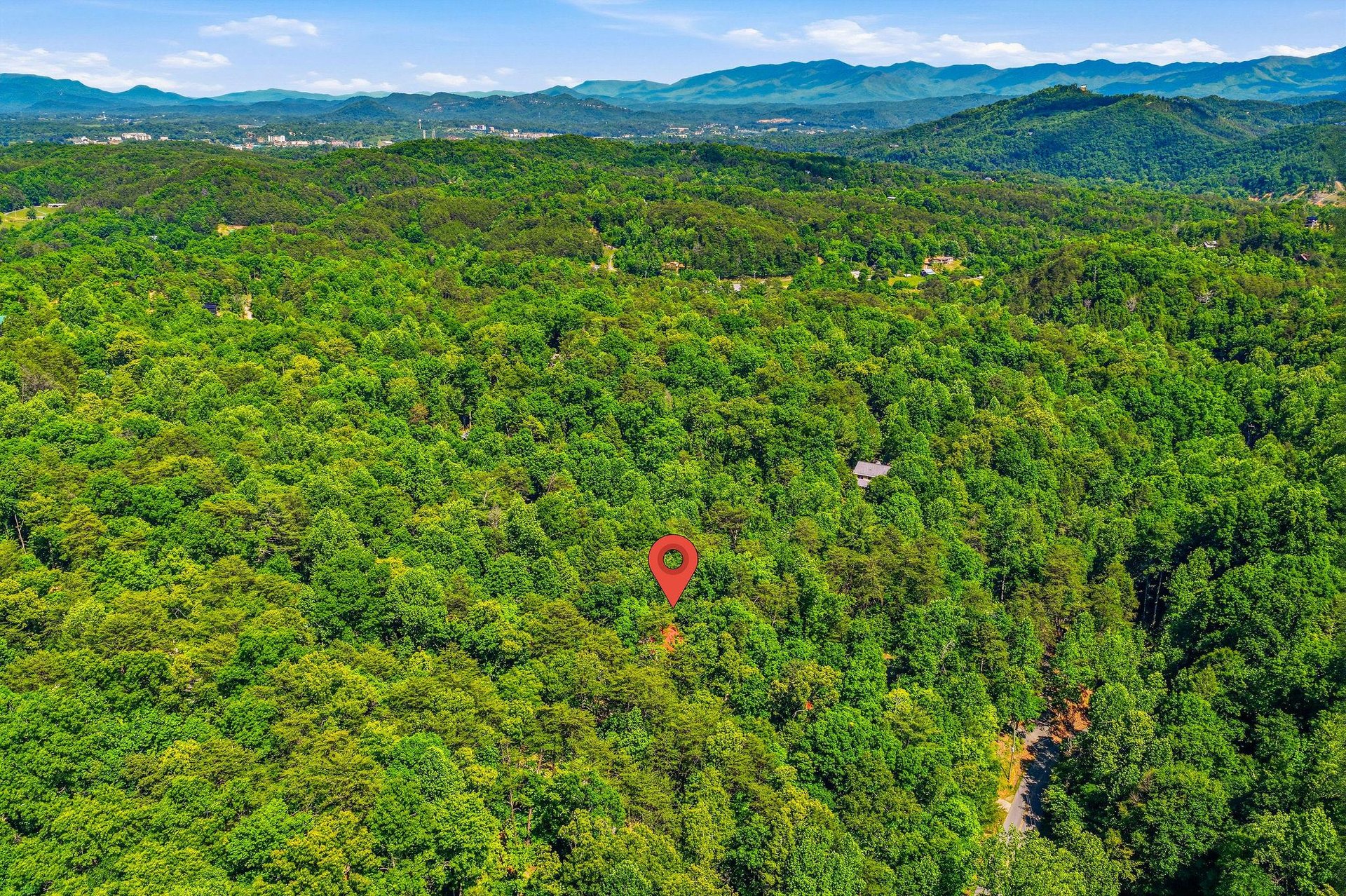 Nestled in the lush Smoky Mountains, this property sits amid dense forest and rolling peaks, offering a secluded mountain escape surrounded by natural beauty.