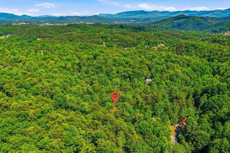Nestled in the lush Smoky Mountains, this property sits amid dense forest and rolling peaks, offering a secluded mountain escape surrounded by natural beauty.