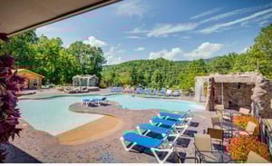 Unwind poolside with mountain views stretching beyond. Your personal oasis awaits with lounge chairs and natural stone features.