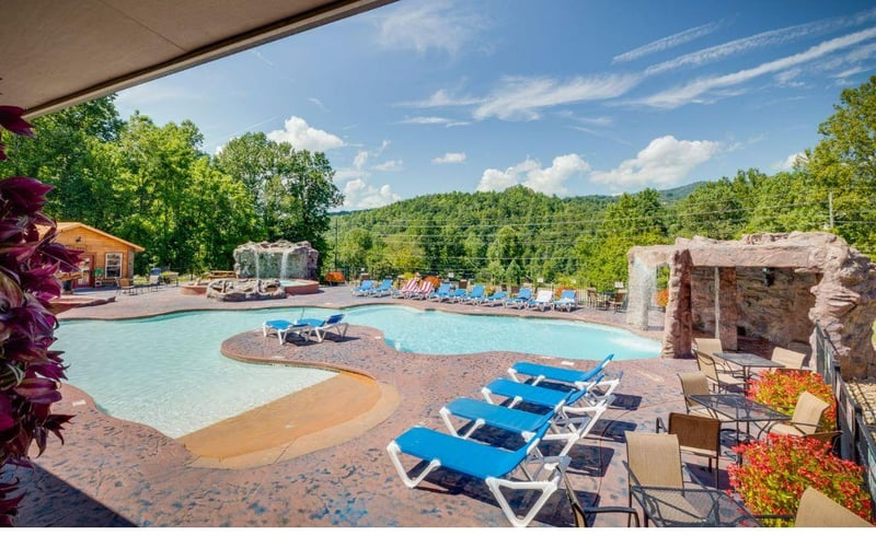 Unwind poolside with mountain views stretching beyond. Your personal oasis awaits with lounge chairs and natural stone features.