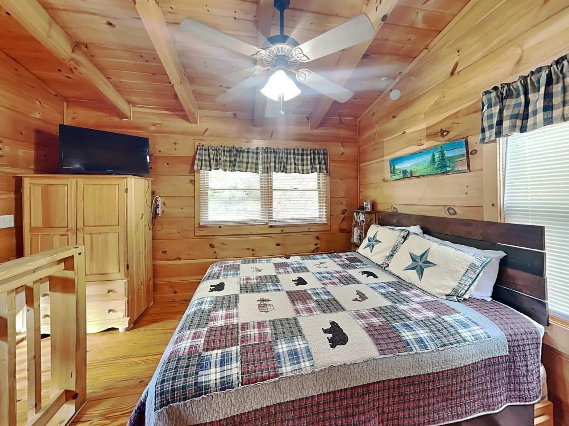 Rest easy in your cozy, rustic bedroom. The warm pine walls and vaulted ceilings create a peaceful retreat where youll wake refreshed and ready for adventure.