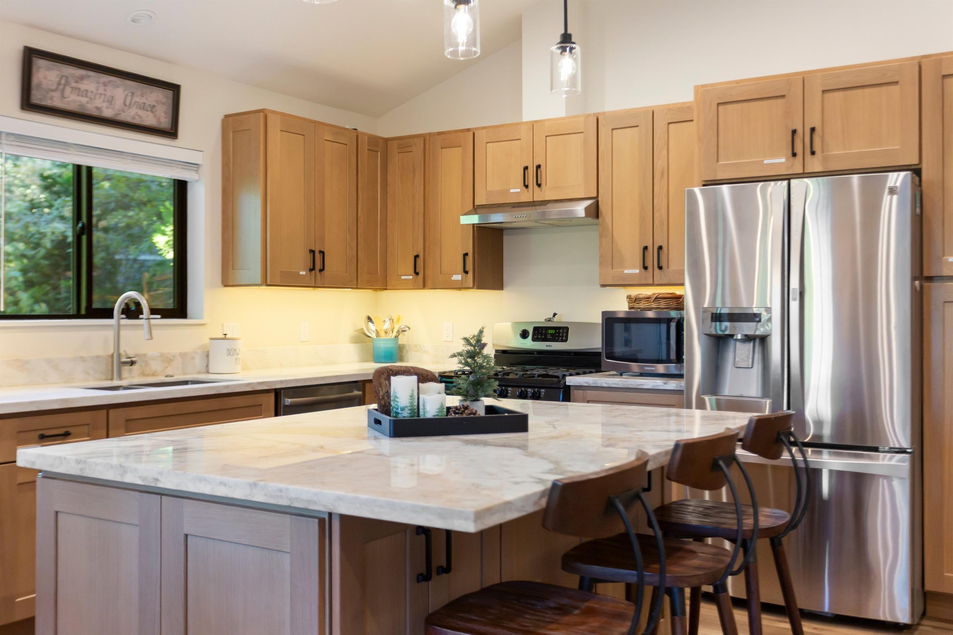 Full kitchen upstairs with stainless steel appliances, coffee station and large island.