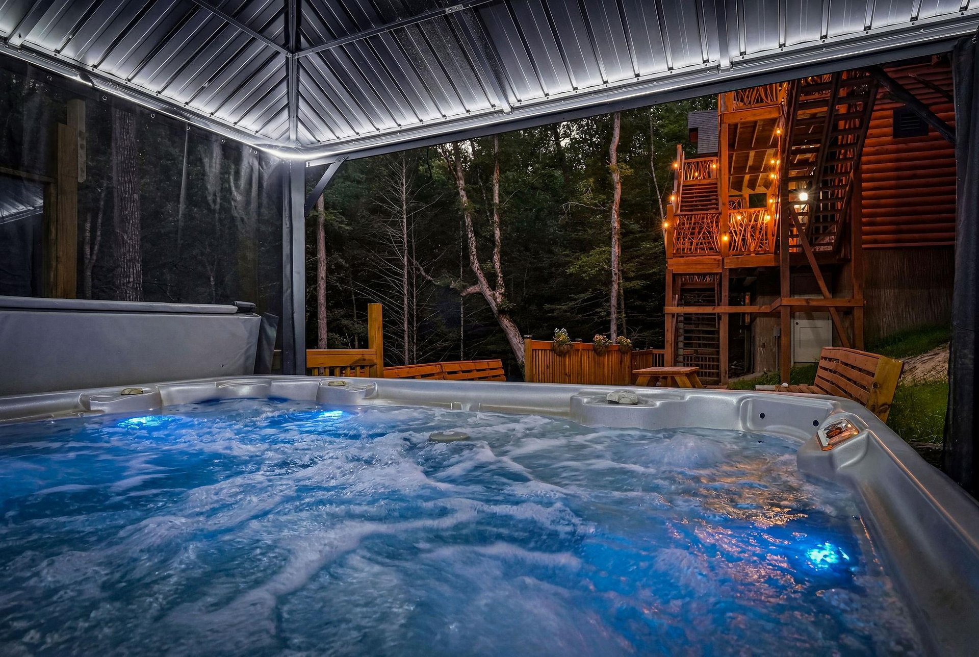 Slip into your private hot tub under the covered deck and let the warm jets melt away your stress as you gaze out at the peaceful forest backdrop.