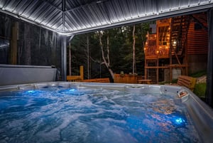 Slip into your private hot tub under the covered deck and let the warm jets melt away your stress as you gaze out at the peaceful forest backdrop.