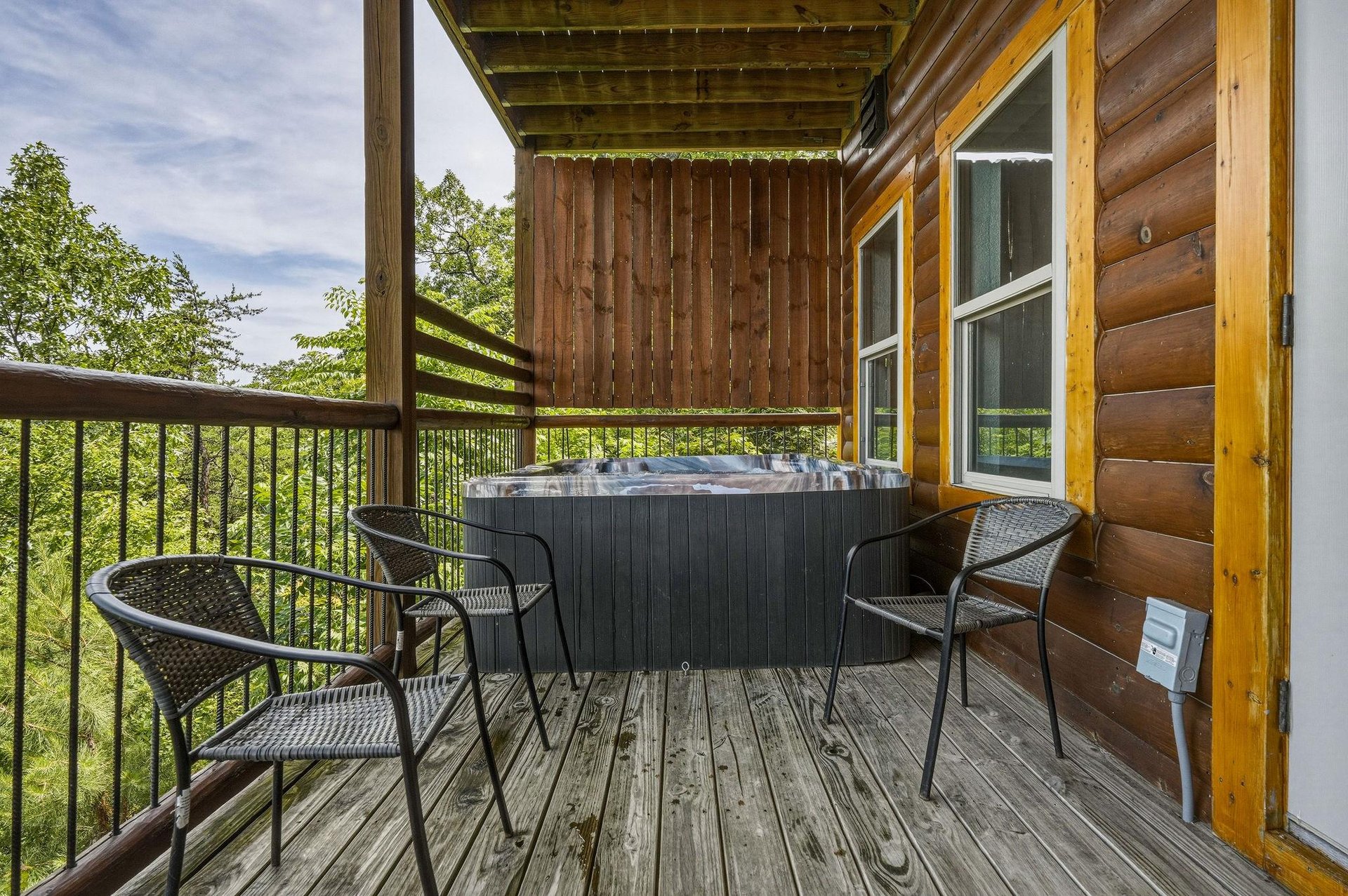 Unwind in your private hot tub on this elevated deck, surrounded by lush forest views and serene mountain air—your perfect escape awaits.