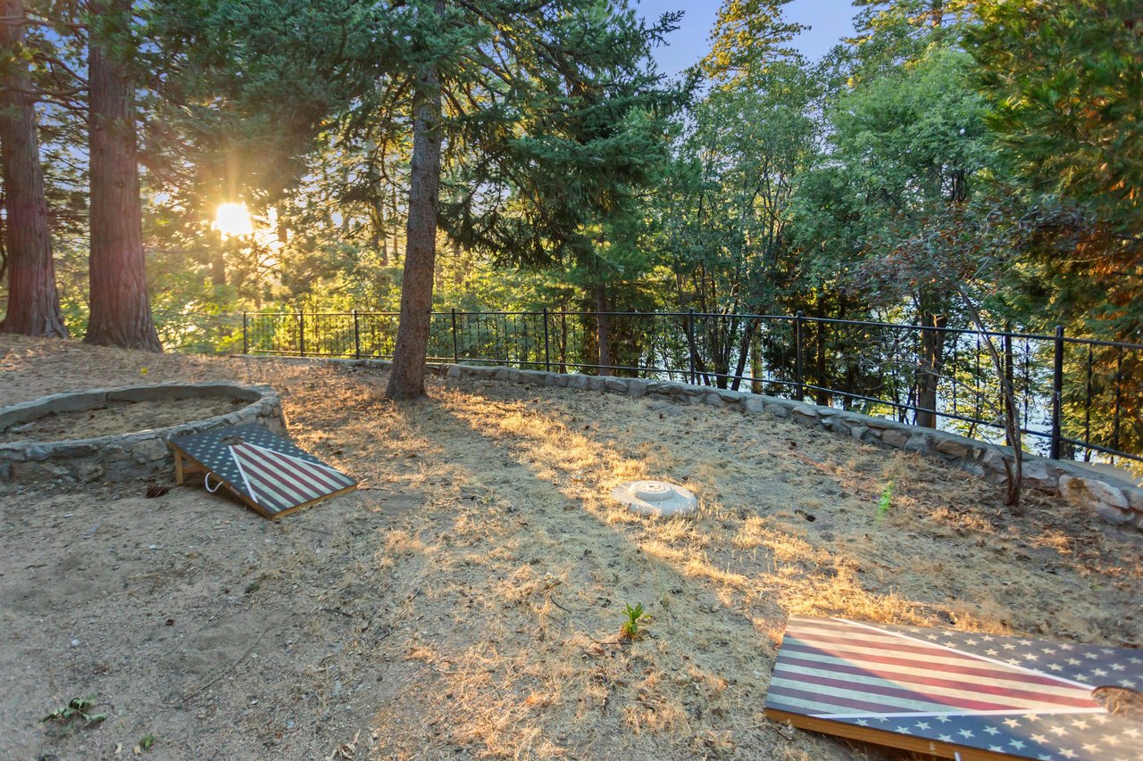 Has plenty of space to enjoy corn hole with a lake view.