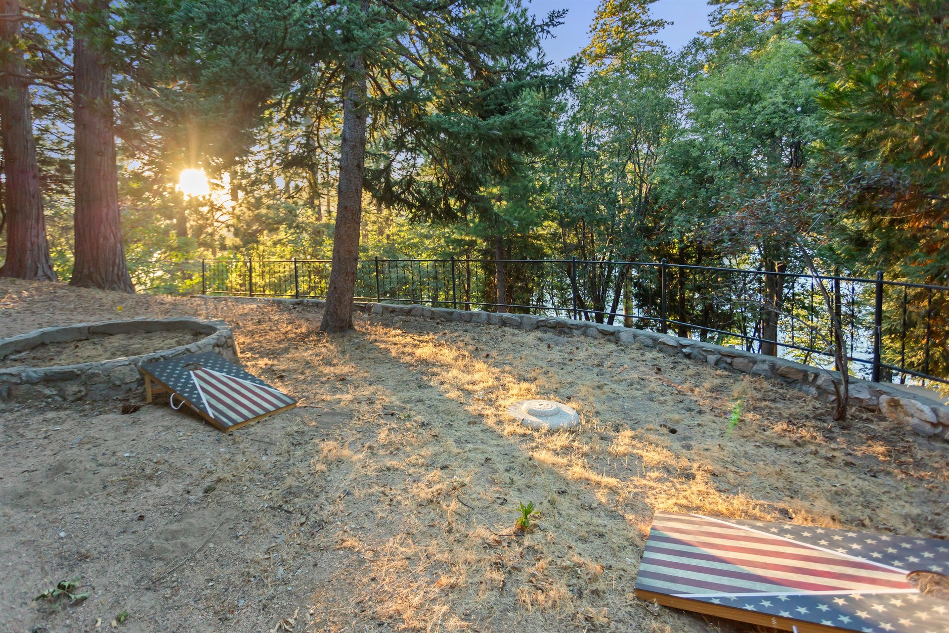 Has plenty of space to enjoy corn hole with a lake view.