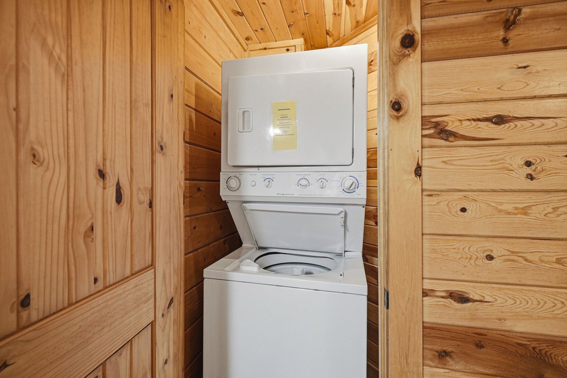 Your private laundry closet keeps you prepared with a washerdryer combo nestled in warm pine walls.