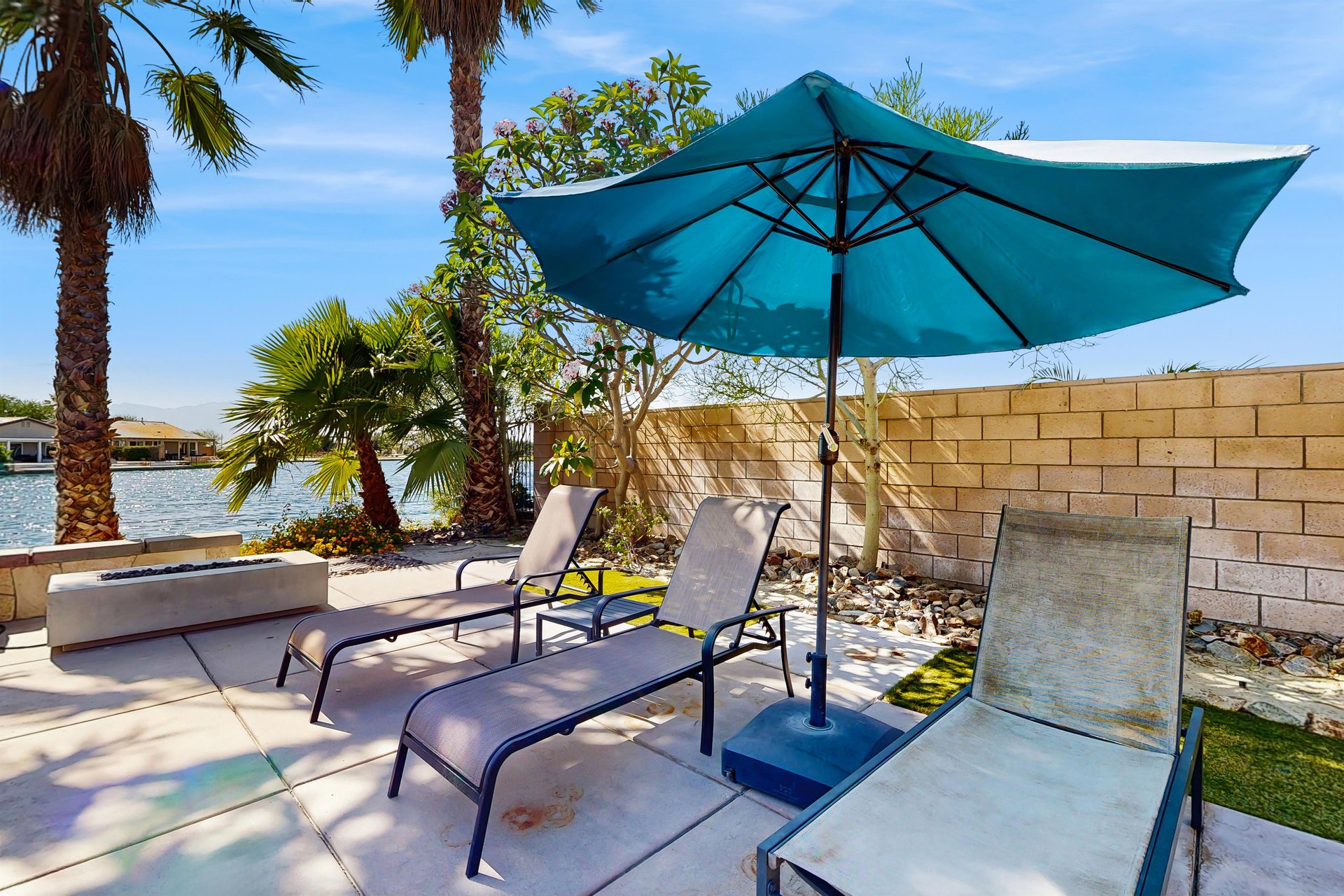 Sun loungers and fire pit overlooking the water.